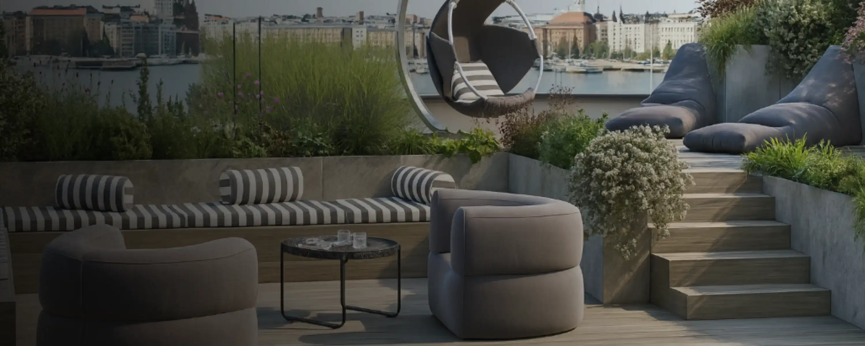 Outdoor terrace scene with bean bags and loungers arranged by poolside